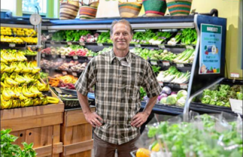 An image of Michael Faber, the general manager of the Monadnock Food Co-op, standing in the produce section of the store.