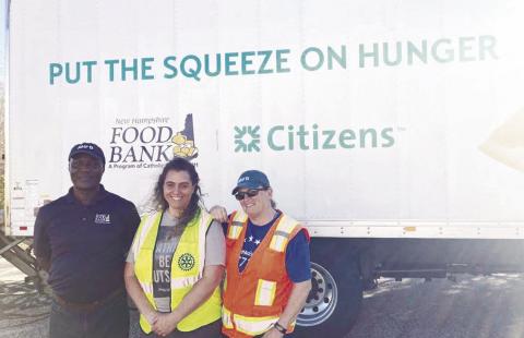 From left John Ombego, Christy Langlois and Brenda Howell of the NH Food Bank brought about 16,000 pounds of food to Ham Arena Monday where it was all distributed.