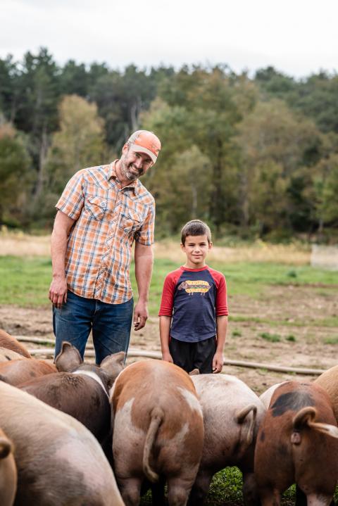 Mark Florenz, owner of Archway Farm in Keene, New Hampshire, with his son.