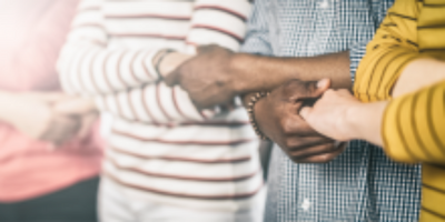 group of people holding hands in solidarity